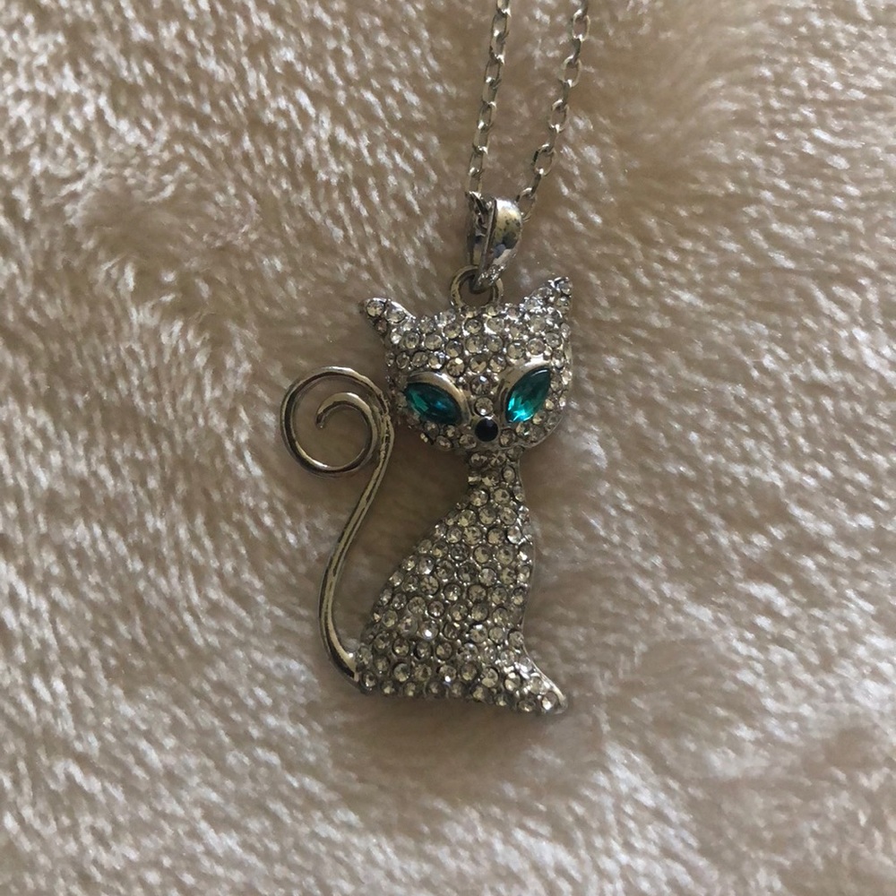 Swarovski necklace of a white cat with aqua eyes
